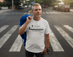 Guy holding hoodie over shoulder  in street wearing god wins tee